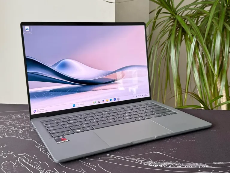 Asus Zenbook A14 open on a wooden surface